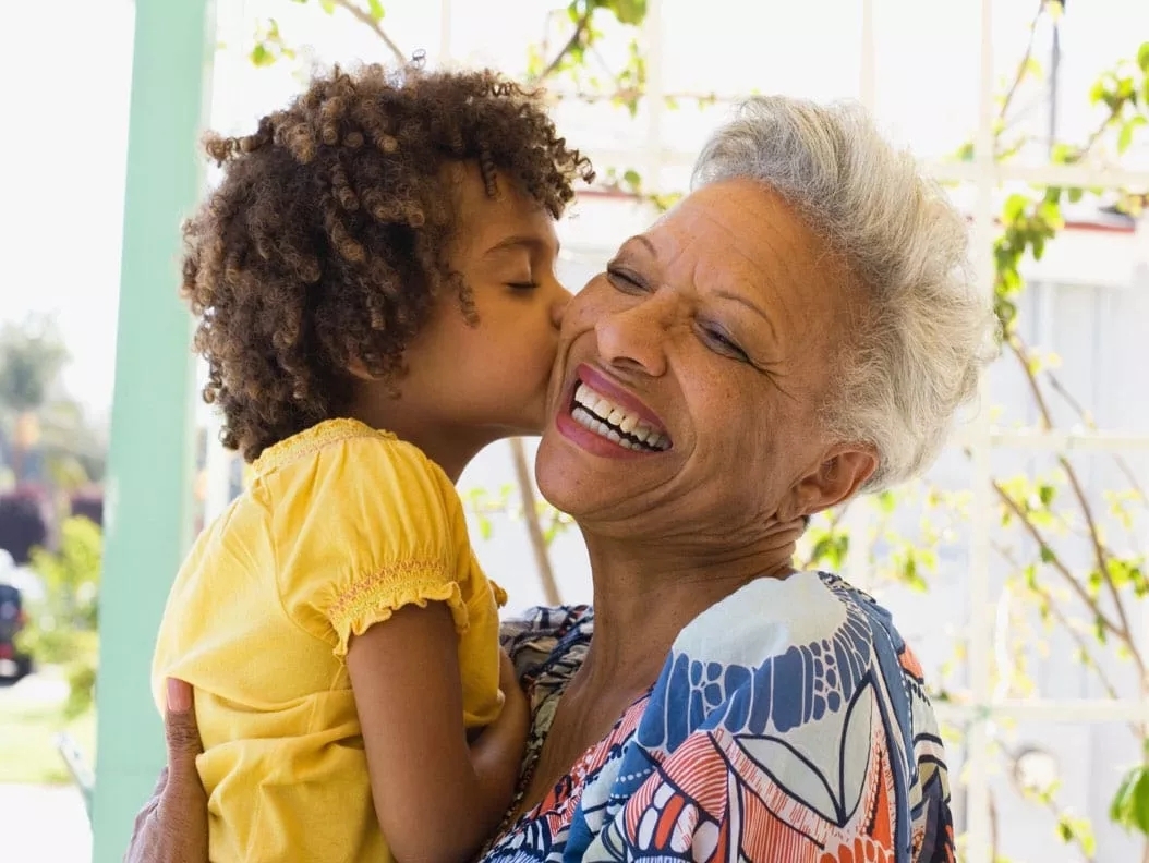 Granddaughter kissing Grandmother